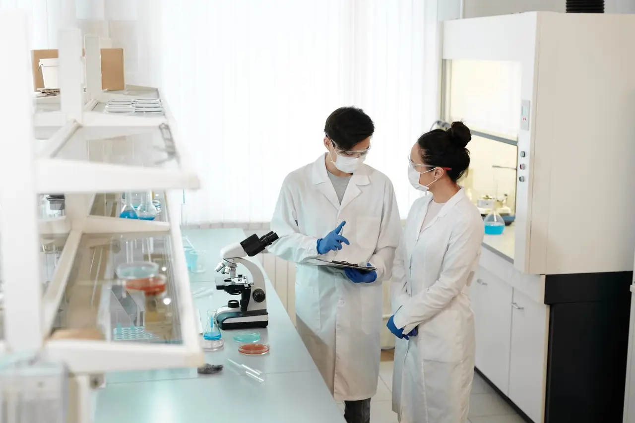 Researchers working beside a microscope in a laboratory